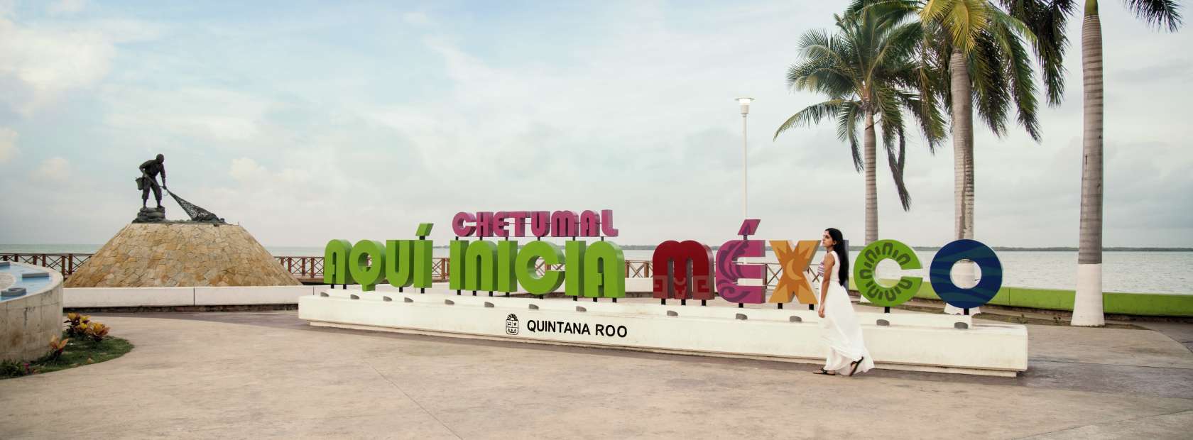 Woman In White Dress Walking Past Chetumal Novi Inicia Mexico Sign