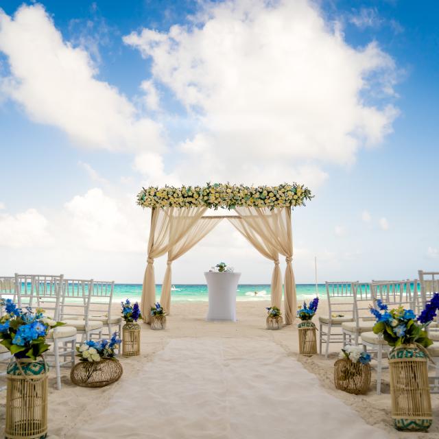 Beach Ceremony Setup with Blue Flowers