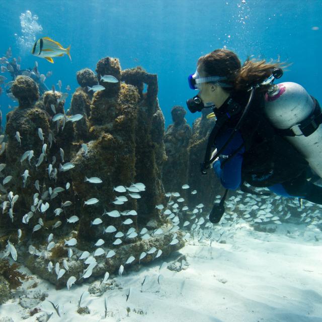Scuba Diver near Underwater Statues