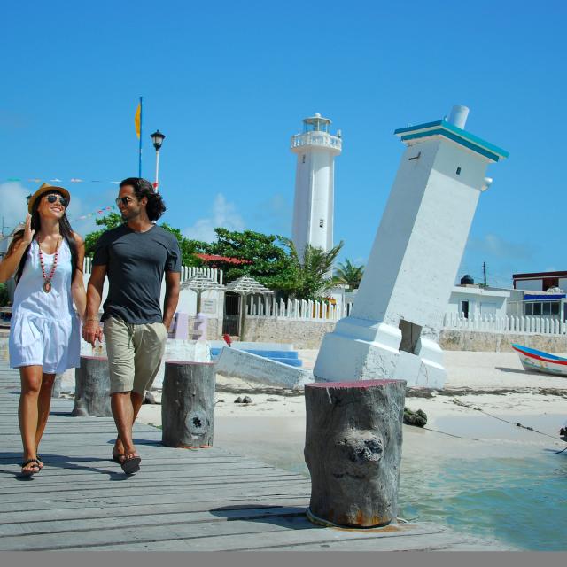 Couple Walking on Pier by Lighthouse