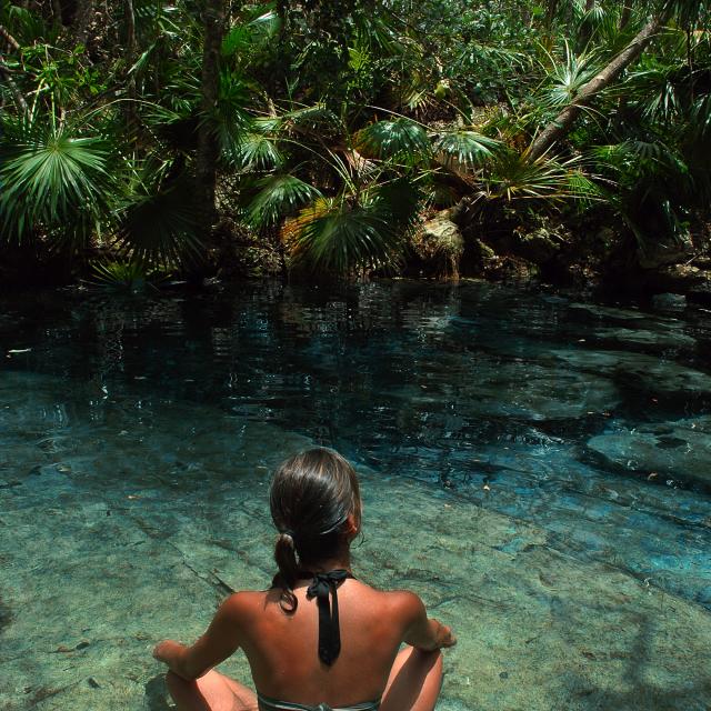 Woman Sitting in Cenote Pool