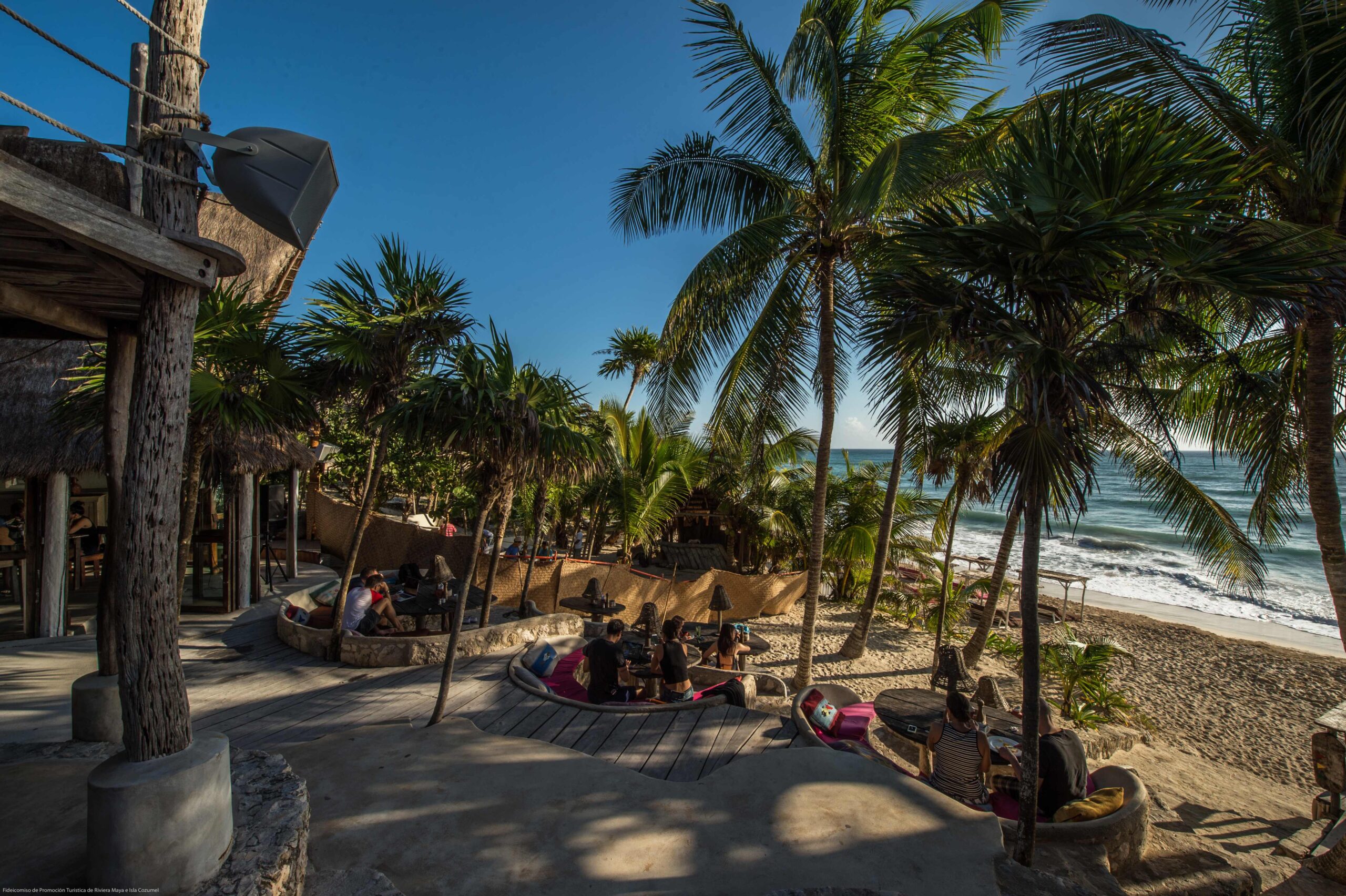 Beach club among palm trees on the Tulum coast