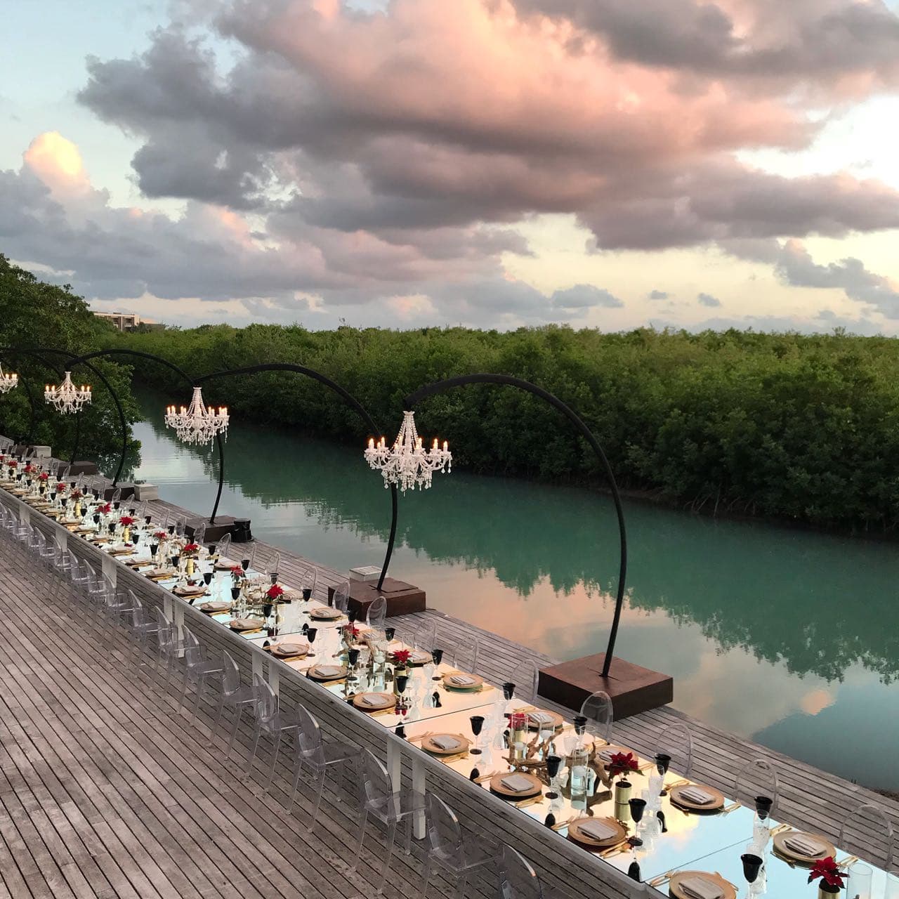 Waterside dinner set-up with chandeliers