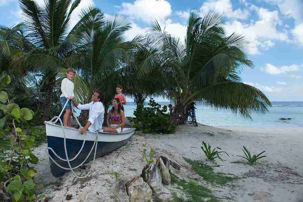 Family with a boat on a bay beach