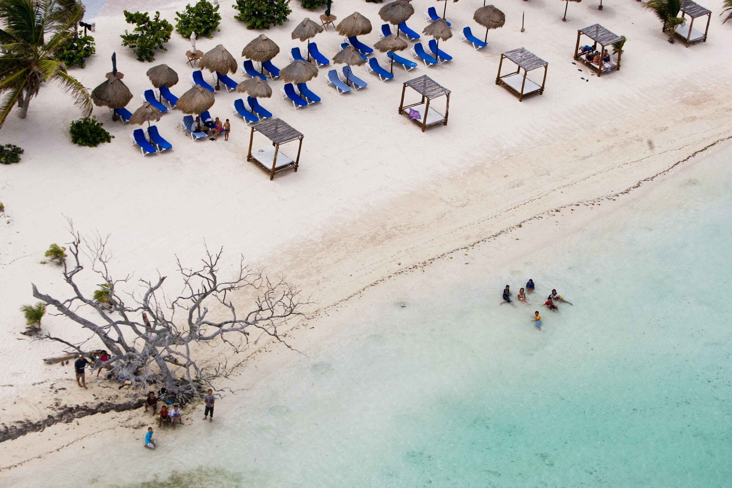 Loungers and palapas on the sand in Mahahual